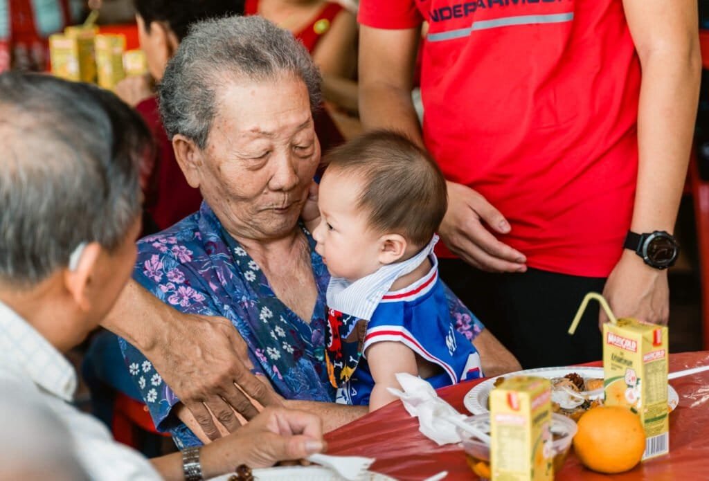 Grandma carrying grandson