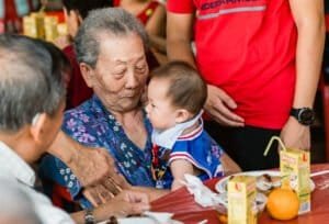 Grandma carrying grandson