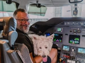 pilot with westie in aircraft